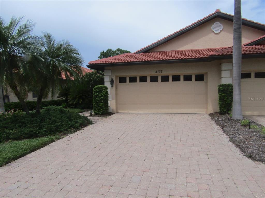 4137 Bella Pasque Venice, FL 34293 - Photo 2 of 30 a front view of a house with a yard and a garage