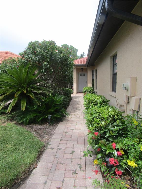 4137 Bella Pasque Venice, FL 34293 - Photo 3 of 30 a view of a pathway with a flower garden