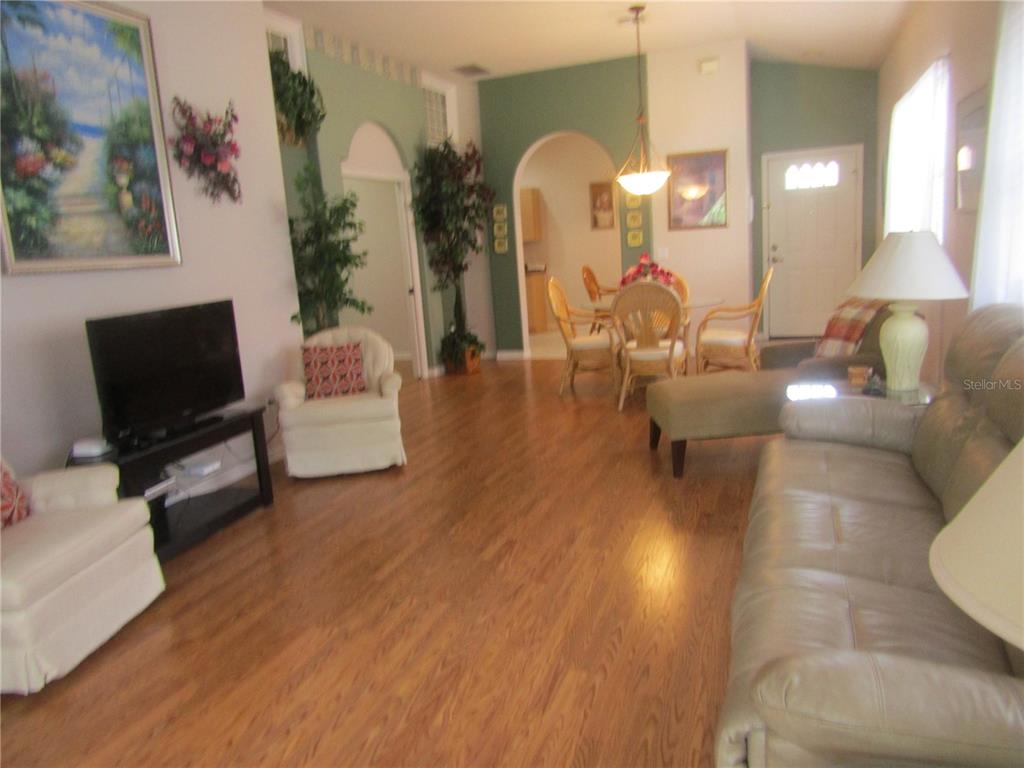 4137 Bella Pasque Venice, FL 34293 - Photo 4 of 30 a living room with couches and a flat screen tv