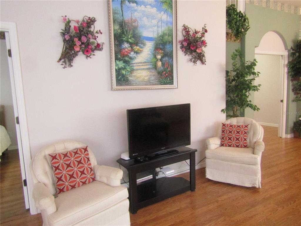 4137 Bella Pasque Venice, FL 34293 - Photo 6 of 30 a living room with furniture and a flat screen tv