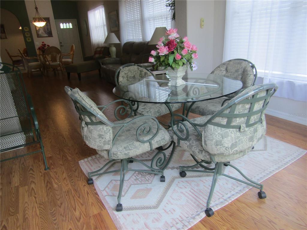 4137 Bella Pasque Venice, FL 34293 - Photo 7 of 30 a dining room with furniture and flowers