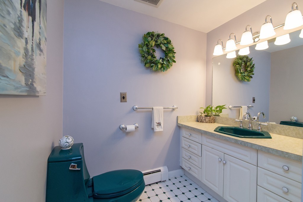 18 Dignon Road Billerica, MA 01821 - Photo 24 of 30 a bathroom with a granite countertop sink mirror and vanity