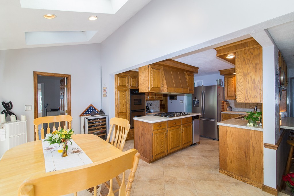 18 Dignon Road Billerica, MA 01821 - Photo 5 of 30 a kitchen with stainless steel appliances granite countertop a sink and a refrigerator
