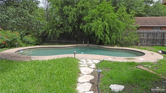 a view of a swimming pool with a yard