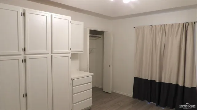 a view of a closet with wooden floor