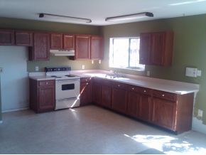 2140 Northeast Clover Palm Bay, FL 32905 - Photo 2 of 8 a kitchen with stainless steel appliances granite countertop a stove a sink dishwasher and a microwave oven