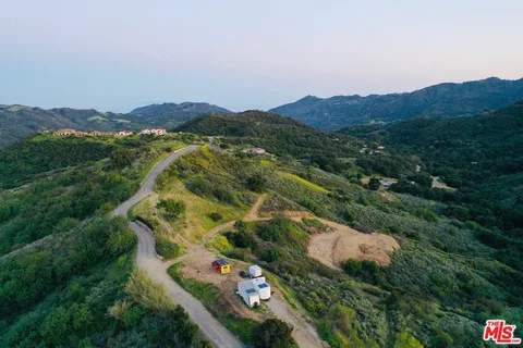 an aerial view of residential house and car parked