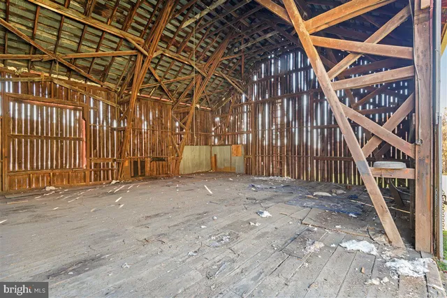 a view of an empty room with wooden stairs