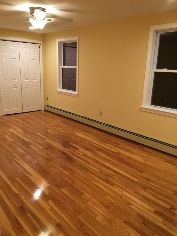 4 Susan Circle Norton, MA 02766 - Photo 15 of 22 a view of an empty room with wooden floor and a window