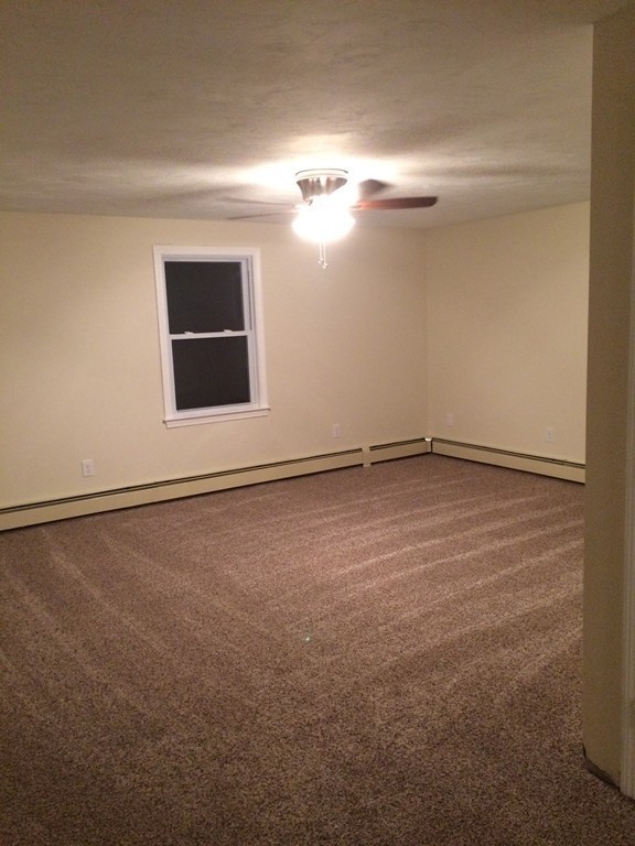 4 Susan Circle Norton, MA 02766 - Photo 19 of 22 a view of an empty room with window and wooden floor