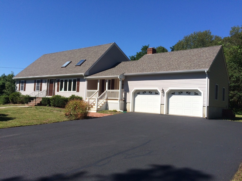 4 Susan Circle Norton, MA 02766 - Photo 2 of 22 a front view of a house with a yard and garage