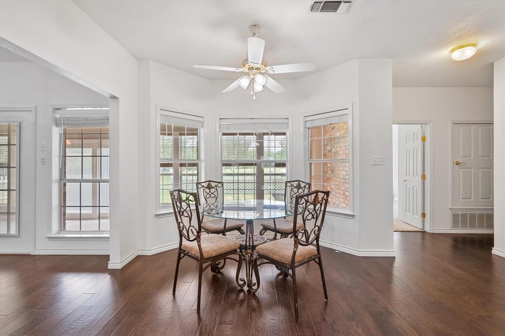 13021 Rudy's Way Streetman, TX 75859 - Photo 10 of 40 Bright breakfast nook near Corsicana surrounded by windows overlooking the fenced patio and outdoor space.