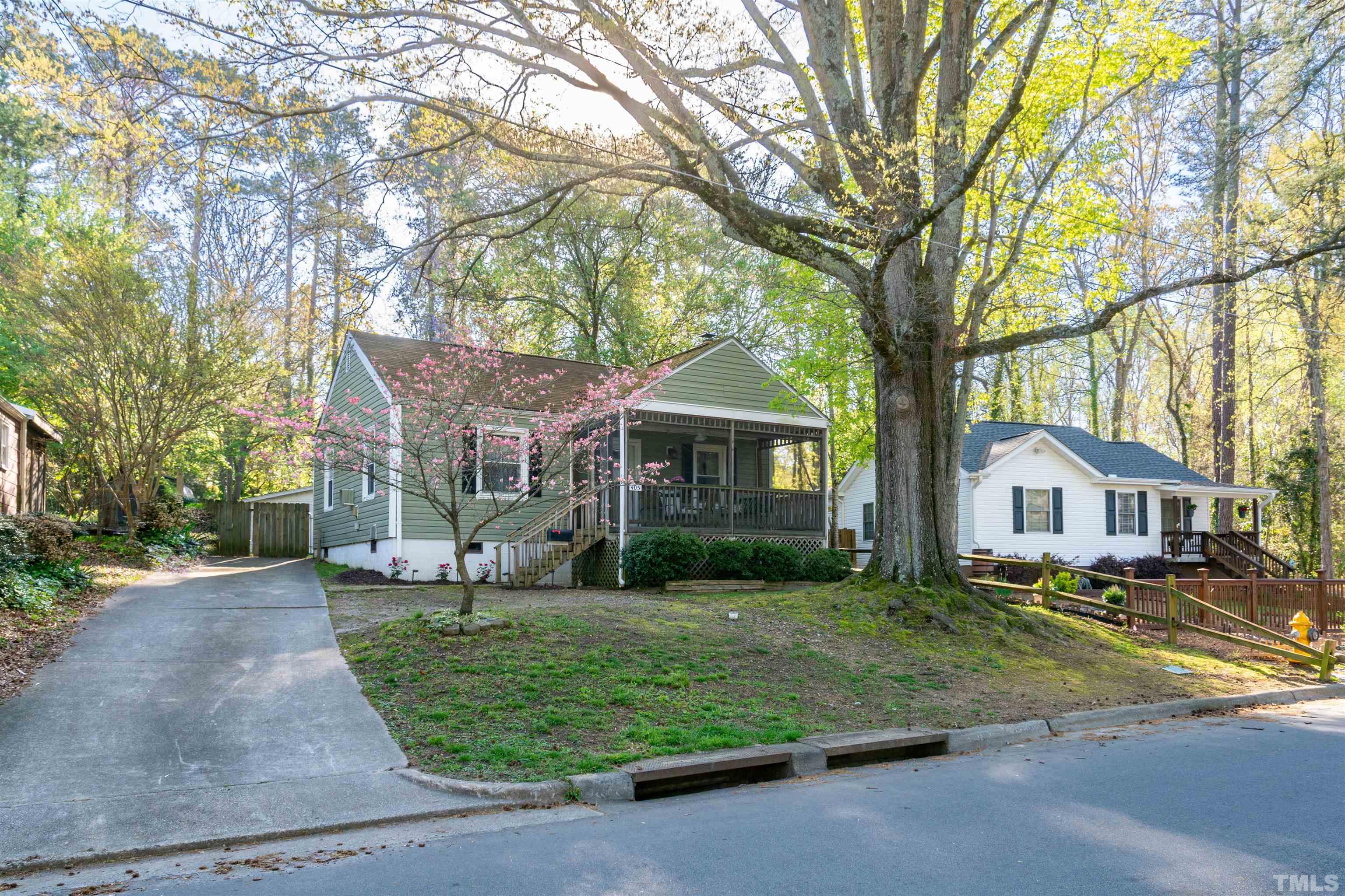 405 Plainview Avenue Raleigh, NC 27604 - Photo 35 of 58 a front view of a house with a garden and trees