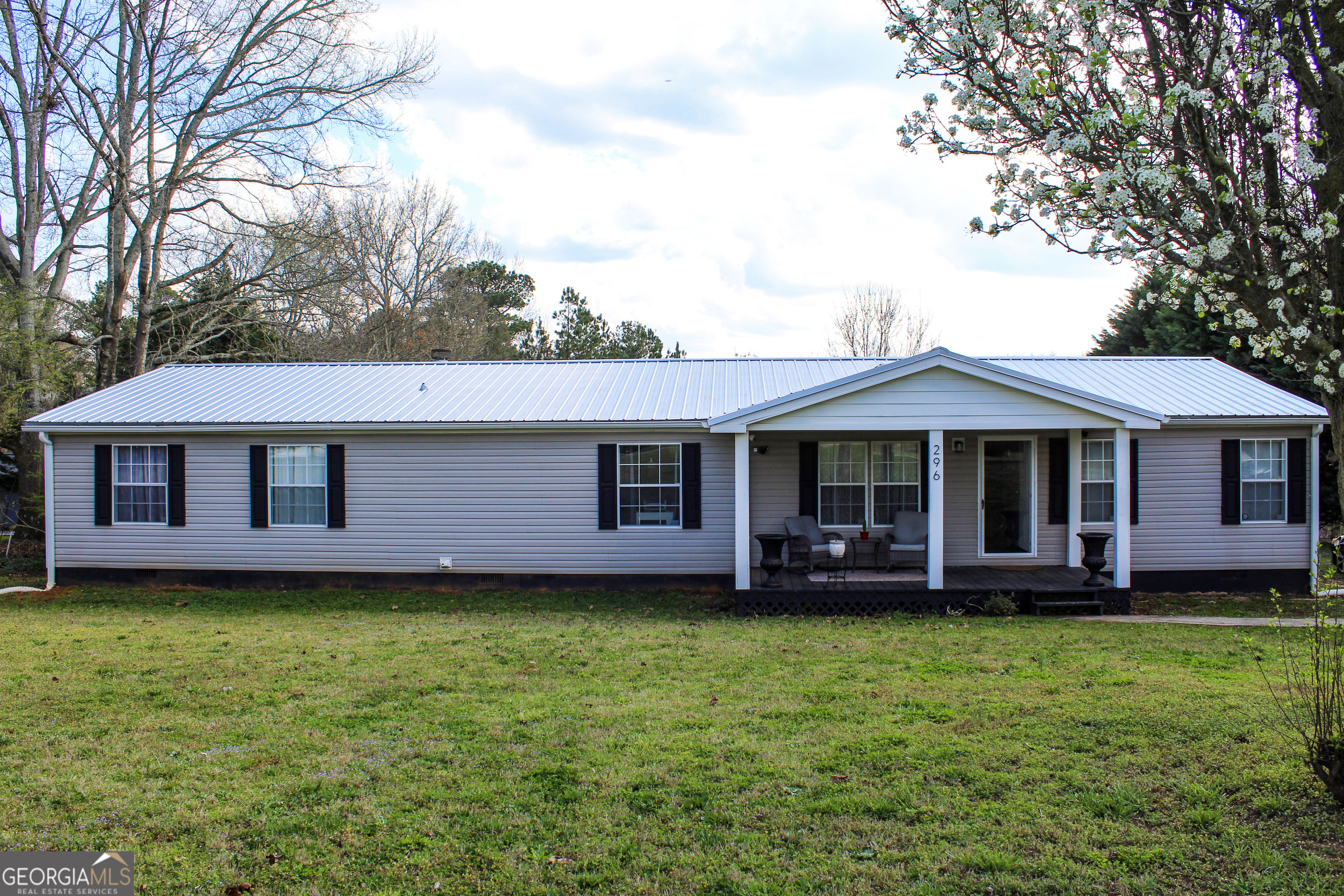 a front view of a house with a garden