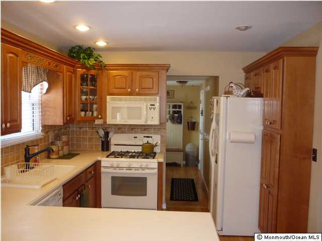 668 Thoroughfare Road Brick, NJ 08724 - Photo 3 of 3 a kitchen with a refrigerator stove and sink