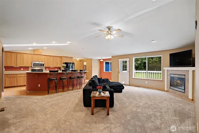 a living room with furniture a fireplace and a flat screen tv