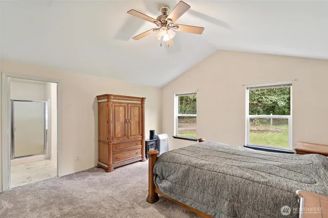 a spacious bedroom with a bed and a window