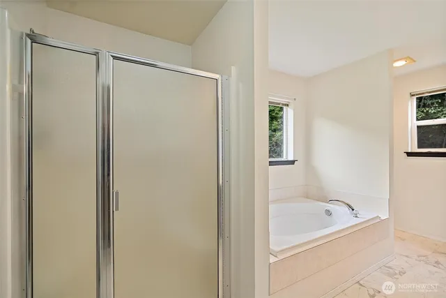 a bathroom with a bathtub and a shower