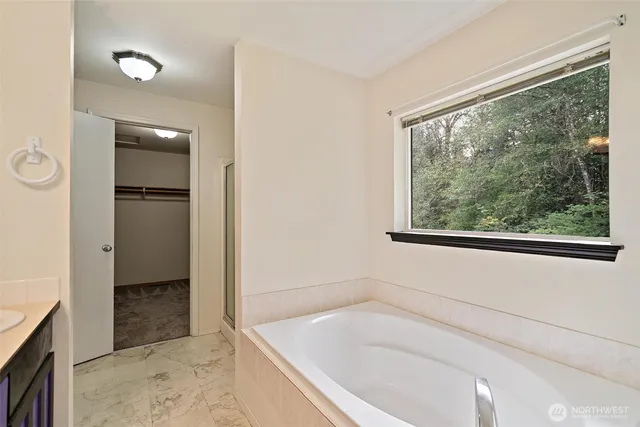 a bathroom with a bathtub and a shower