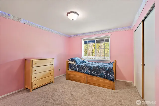 a bed room with a bed and a window