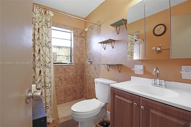 a bathroom with a sink mirror vanity and toilet