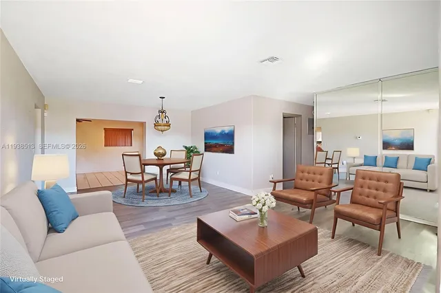 a living room with furniture and wooden floor