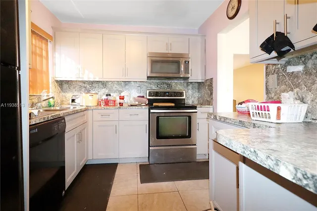 a kitchen with a sink stove and microwave