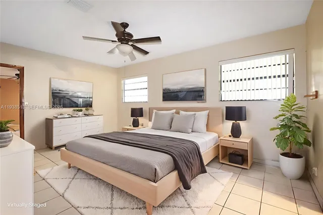 a bedroom with a bed potted plant with the view of kitchen