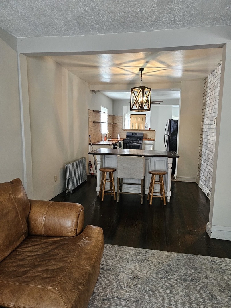 15354 5th Avenue Phoenix, IL 60426 - Photo 3 of 5 a living room with furniture and wooden floor