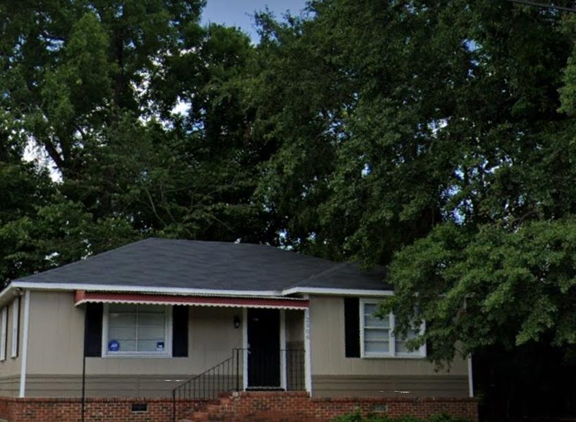 a house with trees in the background