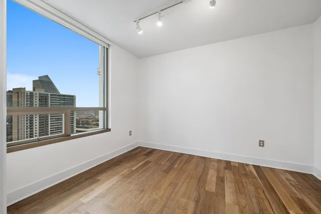 a view of a balcony with floor to ceiling windows with wooden floor