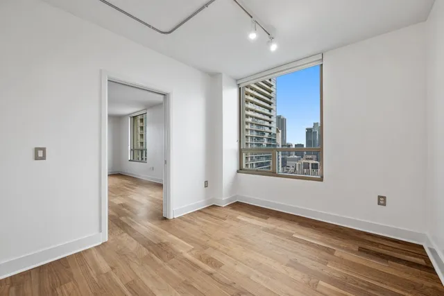 a bathroom with a sink a toilet a mirror and shower