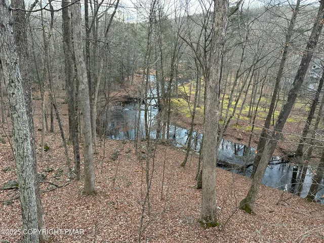 a kitchen with stainless steel appliances granite countertop a refrigerator a sink a stove and a microwave