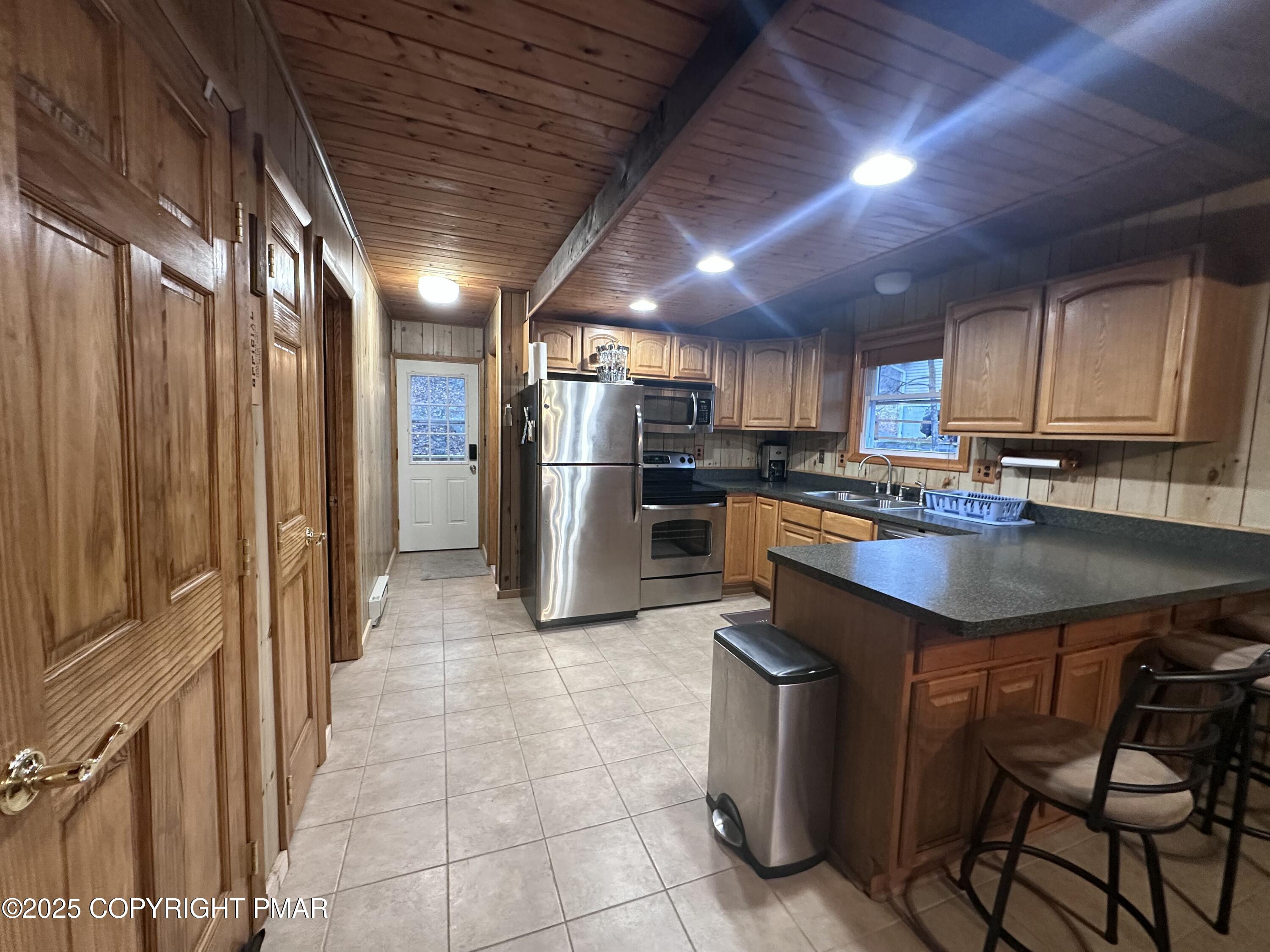 5880 Decker Road Bushkill, PA 18324 - Photo 5 of 51 a kitchen with stainless steel appliances granite countertop a refrigerator a sink a stove and a microwave