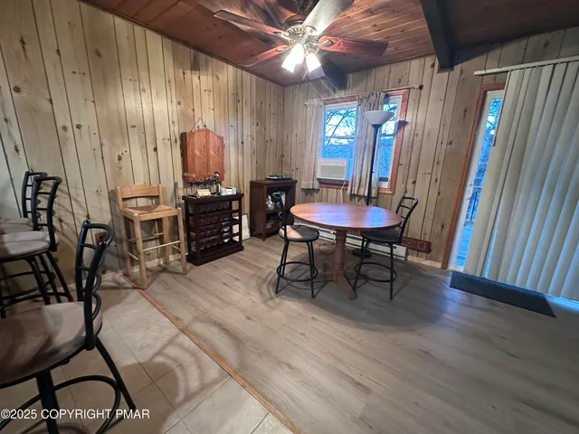 a view of a house with a yard and large trees