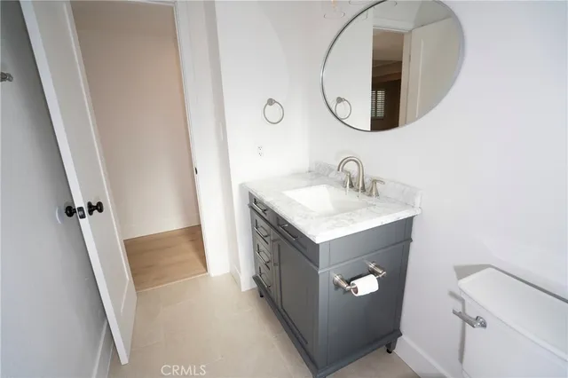 a bathroom with a sink vanity and a mirror