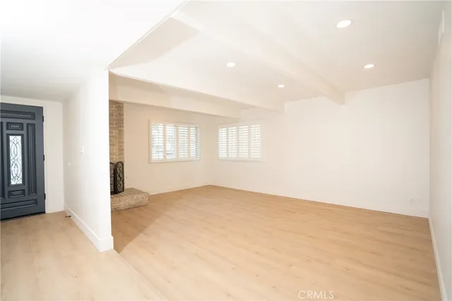 an empty room with windows and closet