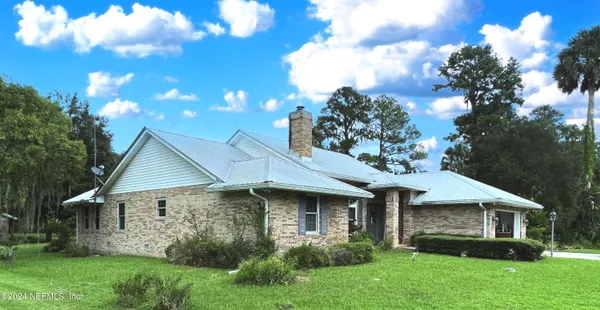 a front view of house with a garden