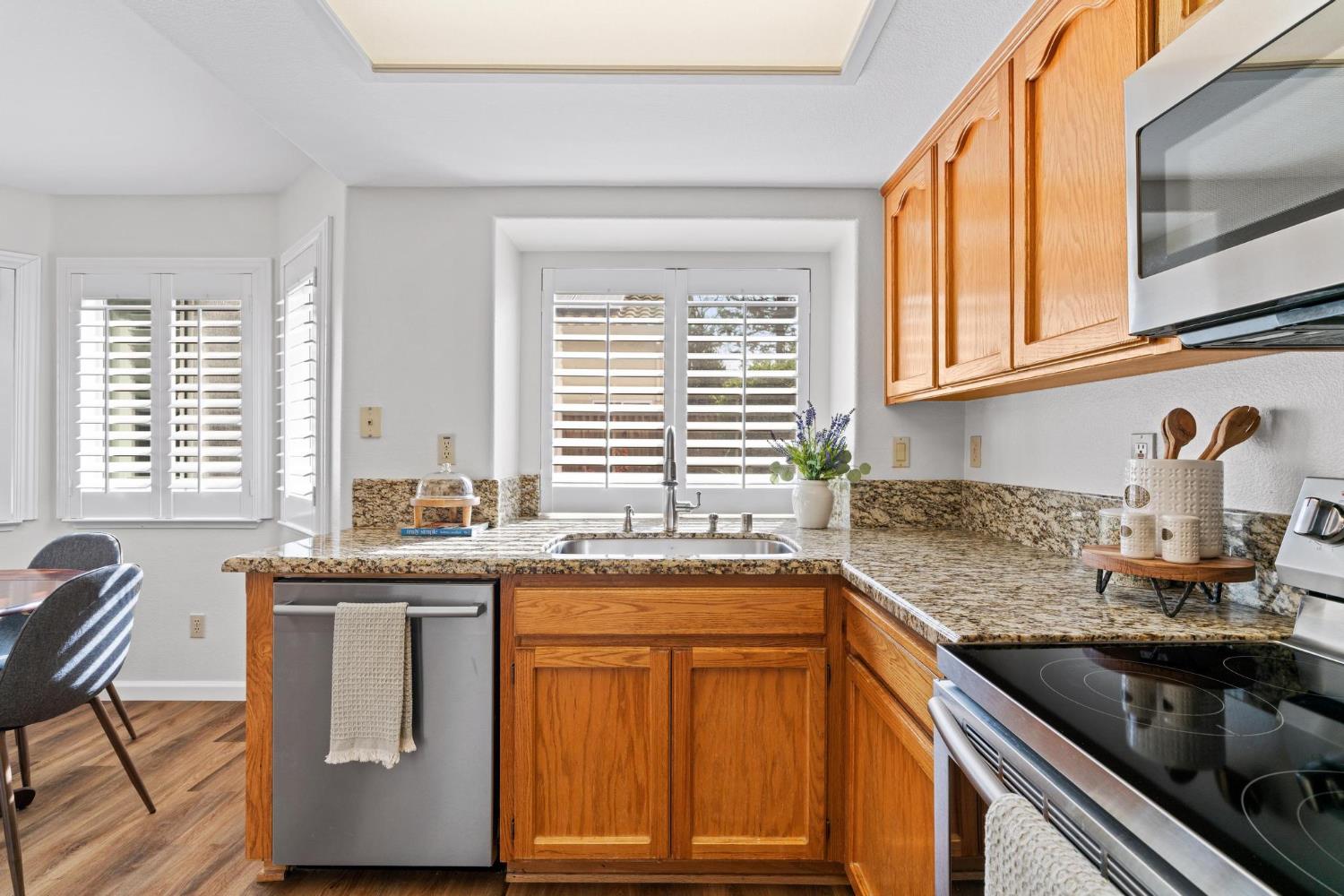 716 Hemmingway Court Tracy, CA 95376 - Photo 15 of 41 a kitchen with stainless steel appliances granite countertop a sink and a window