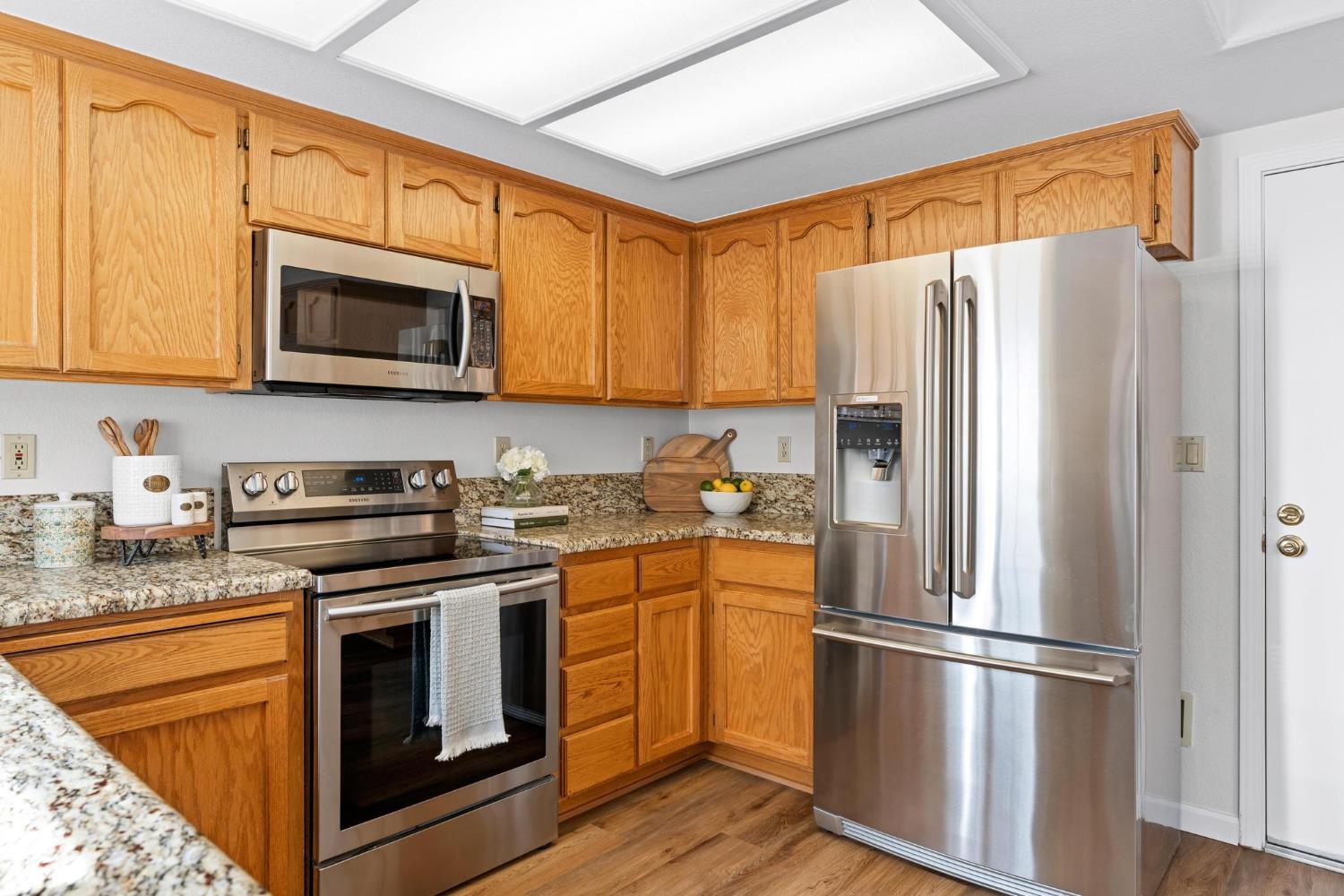 716 Hemmingway Court Tracy, CA 95376 - Photo 16 of 41 a kitchen with stainless steel appliances granite countertop a refrigerator stove top oven and sink