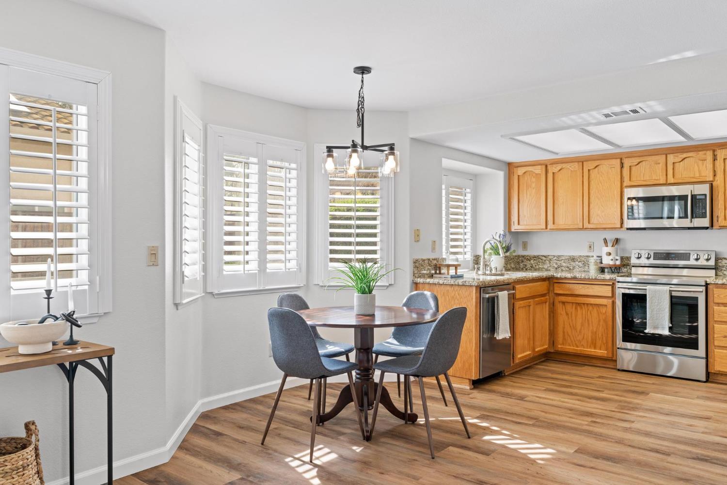 716 Hemmingway Court Tracy, CA 95376 - Photo 17 of 41 a view of a dining room with furniture window and wooden floor