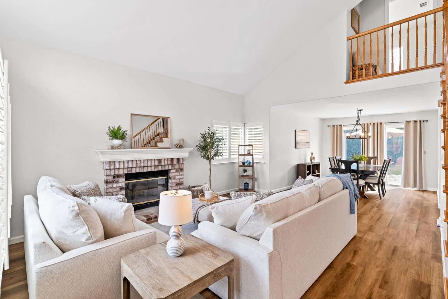 716 Hemmingway Court Tracy, CA 95376 - Photo 3 of 41 a living room with furniture a fireplace and a potted plant