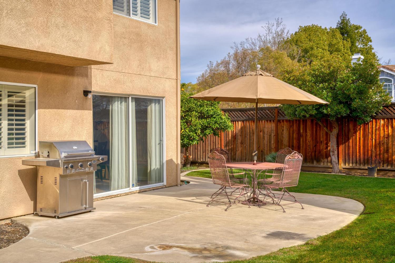 716 Hemmingway Court Tracy, CA 95376 - Photo 32 of 41 a view of a chair and table in backyard of the house