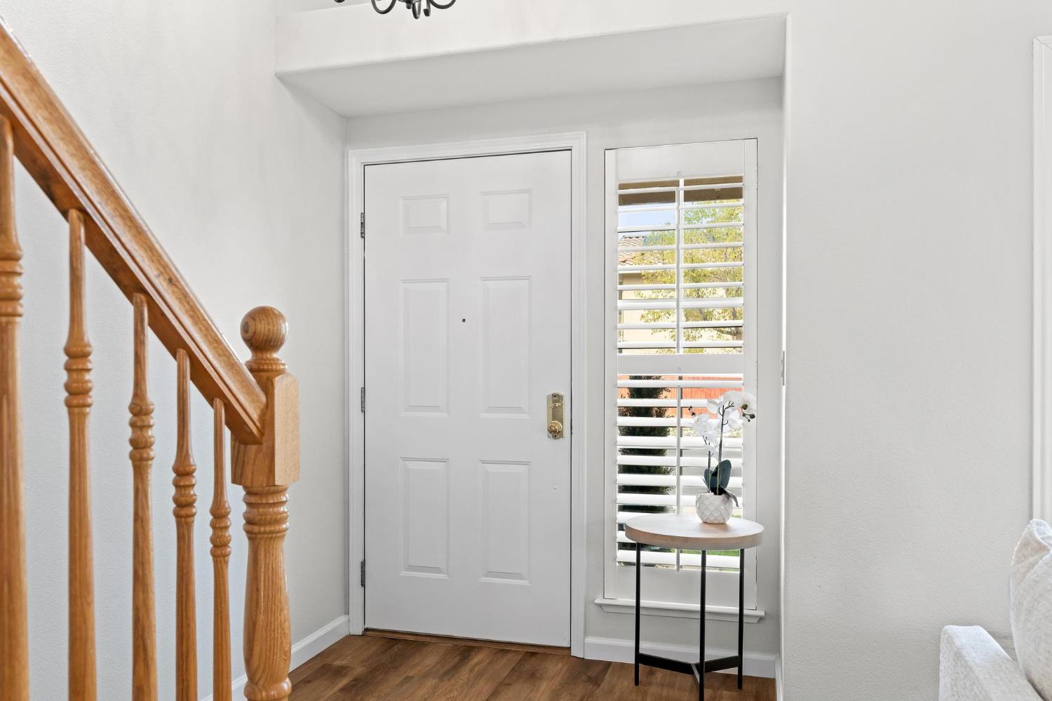 716 Hemmingway Court Tracy, CA 95376 - Photo 10 of 41 a view of a hallway with wooden floor and stairs