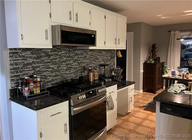 a kitchen with a stove and a microwave