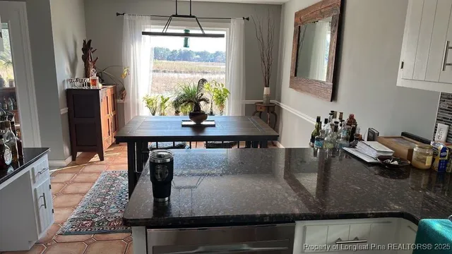 a dining room with table chairs and chandelier
