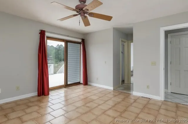 a view of a livingroom with a ceiling fan and window
