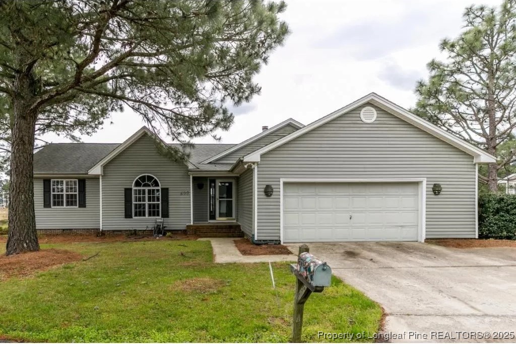 692 Cedar Point Vass, NC 28394 - Photo 2 of 46 a front view of house with yard and trees around