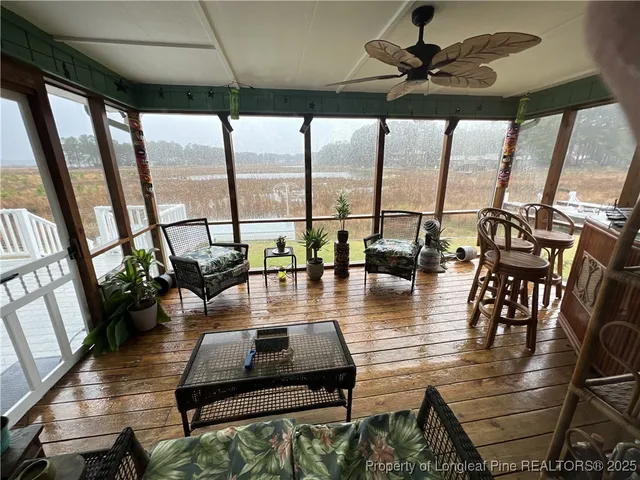 a living room with fireplace furniture and a large window