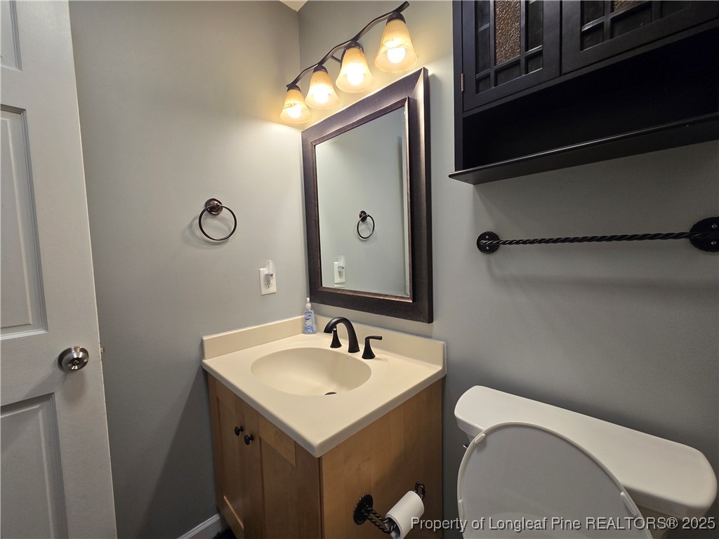 692 Cedar Point Vass, NC 28394 - Photo 34 of 46 a bathroom with a toilet a sink and mirror